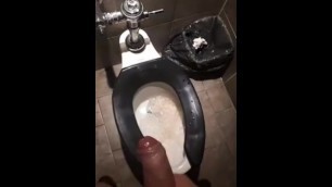 Spraying on the Wall in a Bathroom Stall