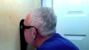 Two guys sharing a mouth in a glory hole